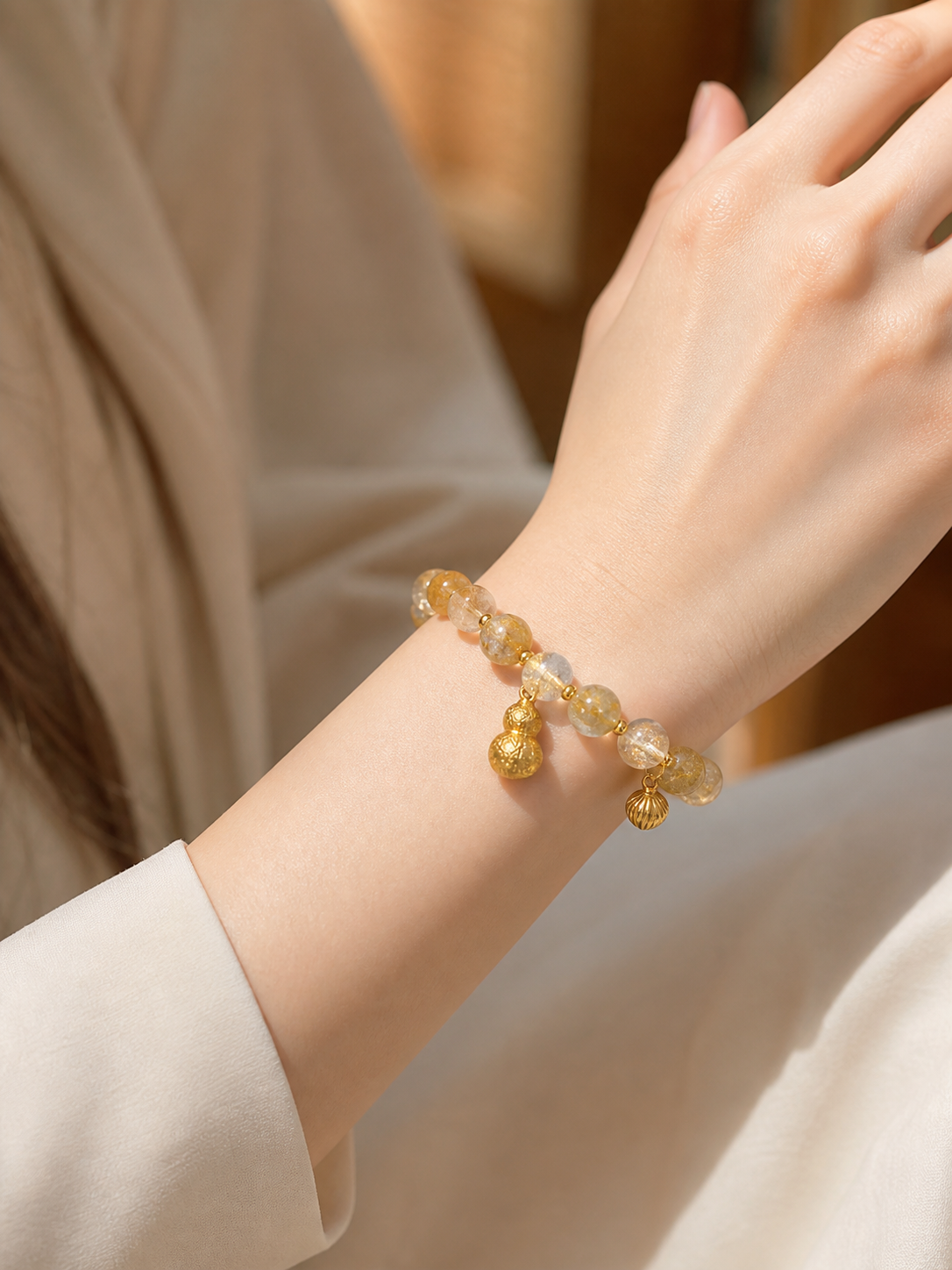Cat’s-eye and rutilated quartz bracelet crystal bead close-up
